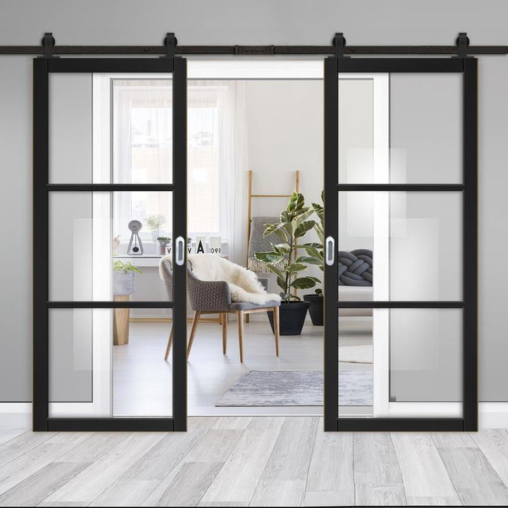 Stylish black-framed sliding glass doors with textured glass panels in a contemporary living space