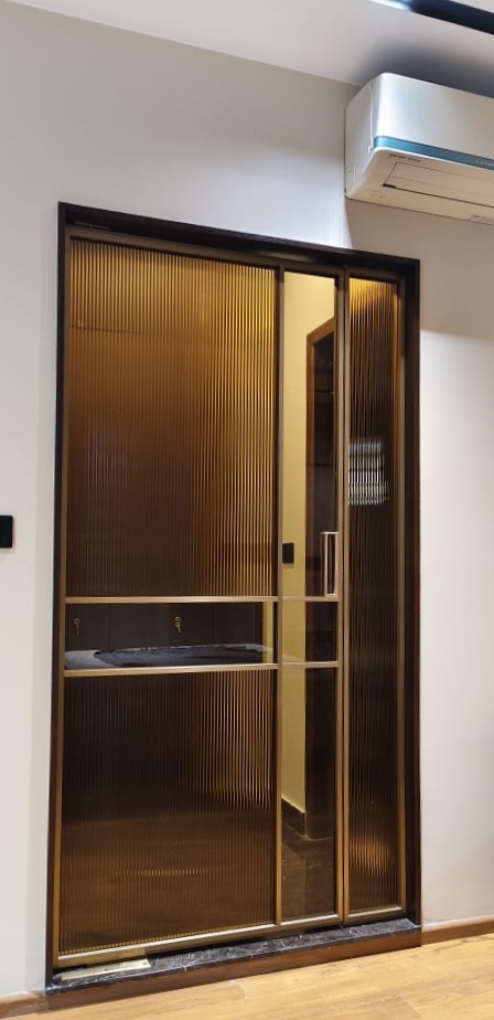 Elegant bronze sliding glass door with ribbed glass for privacy and style